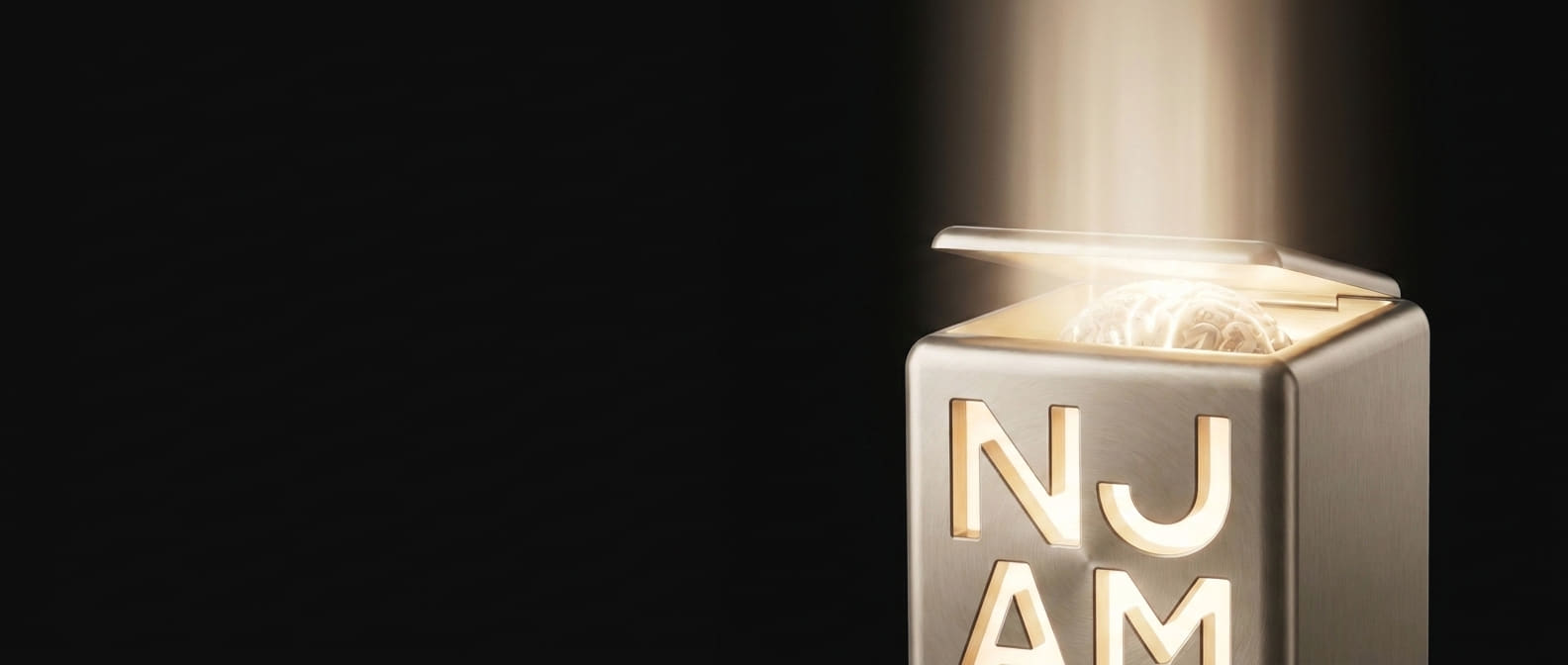 The champagne-metal cube with its lid lifted, warm light pouring upward from the brain inside.